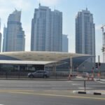 A Dubai Metro Red Line train at an elevated station, the network visitors can actually ride while new lines are still being built.