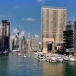 A Dubai Marina hotel tower with marina water and promenade in view, away from Dubai ATM week hotels on the Trade Centre strip.