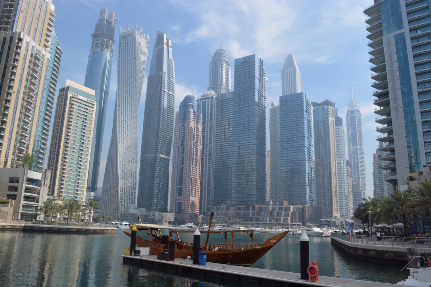 Dubai Marina waterfront towers in daylight, a cooler evening base for companions while attendees use Expo City Dubai metro.
