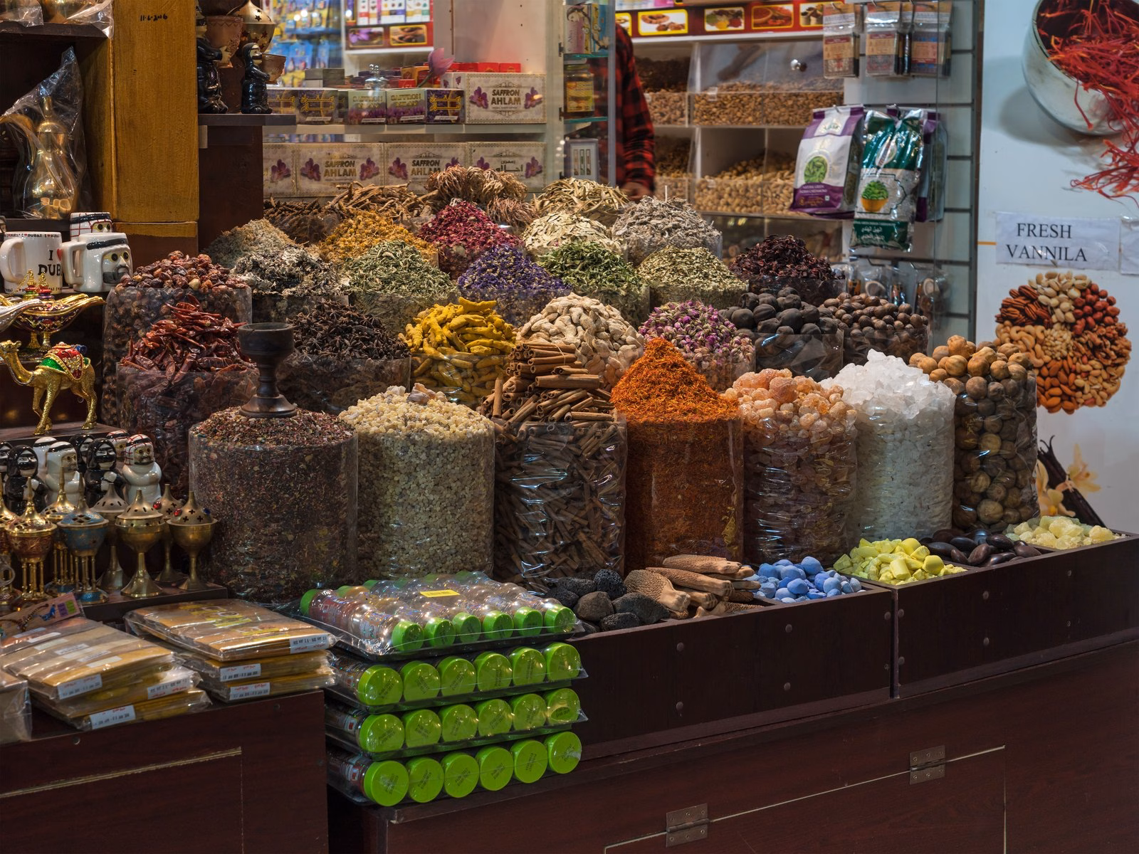Open sacks of spices, dried flowers and herbs at a stall in the Deira Spice Souk, a short walk from the Dubai Gold District