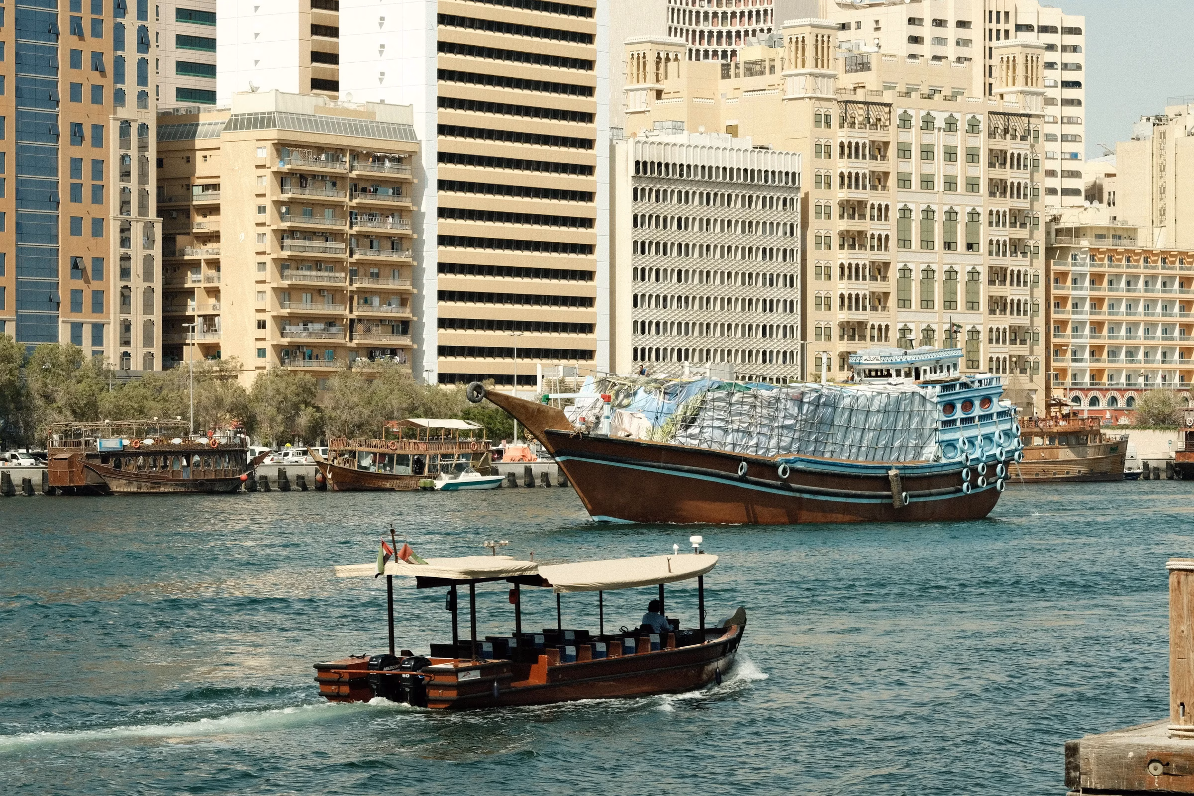 Wooden dhow and abra on Dubai Creek, the waterway Sheikh Rashid had dredged from 1959