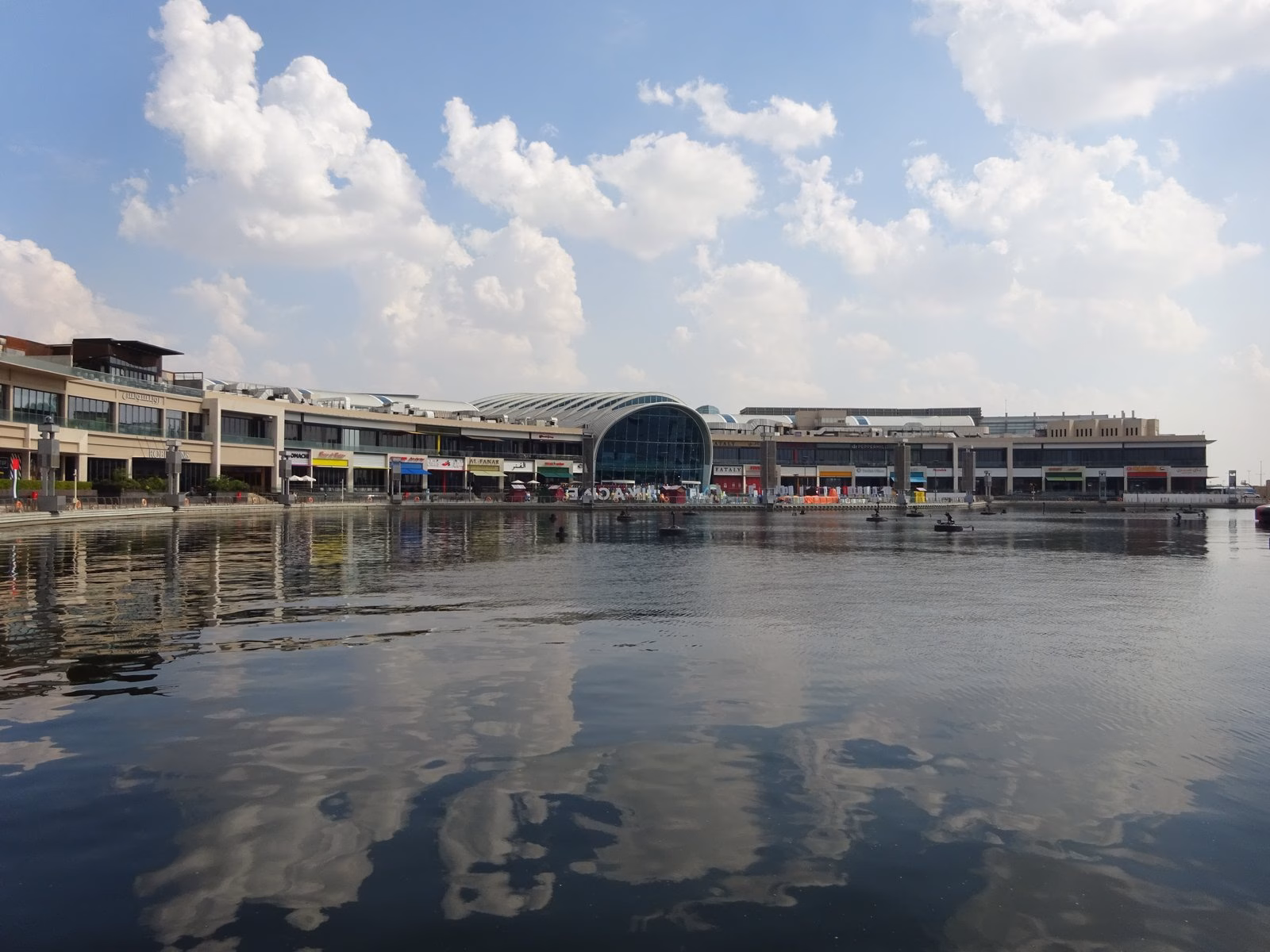 Calm water of the Dubai Festival City marina on Dubai Creek with the waterfront buildings behind, near Marsa Boulevard