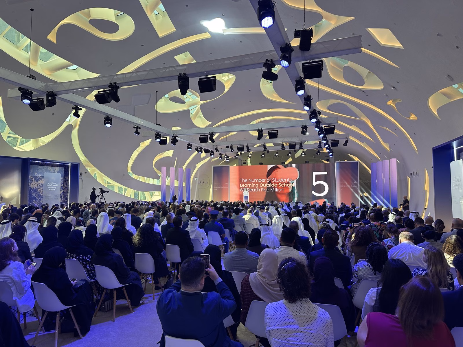 A large audience seated beneath curved lighting at Dubai Future Forum 2024, an earlier Dubai Future Foundation event before Dubai Future Week 2026