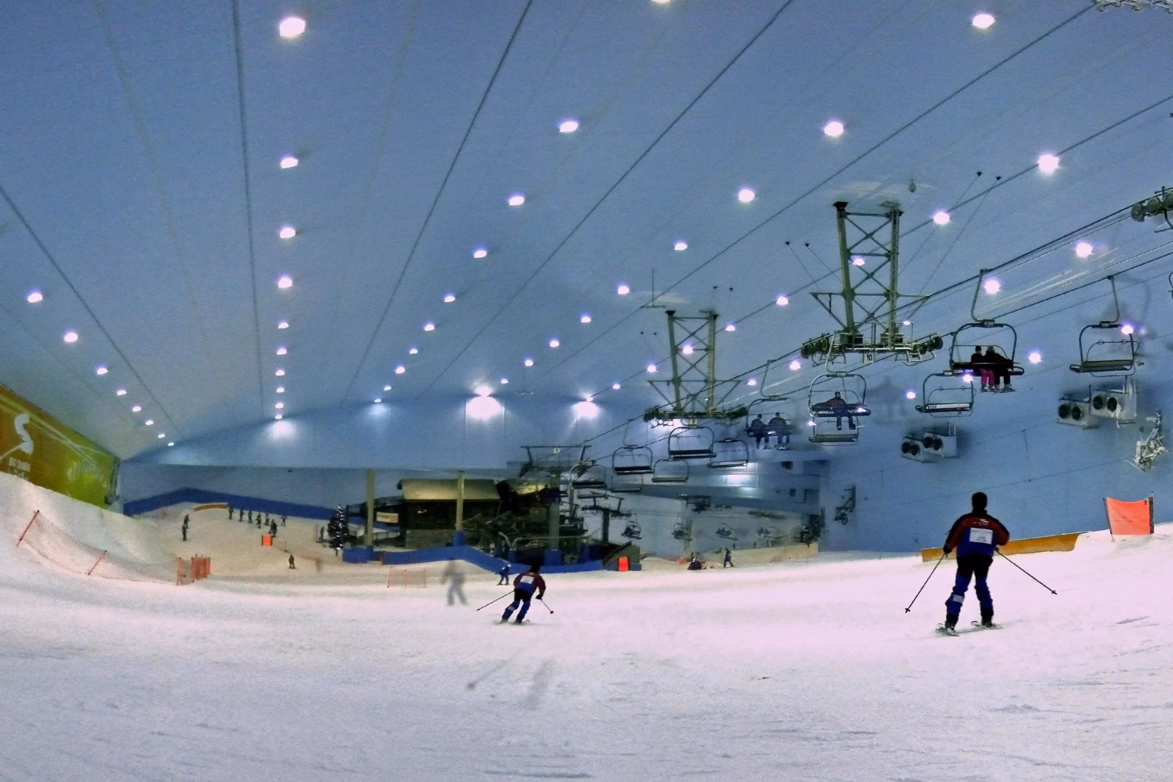 Skiers on the indoor slope at Ski Dubai in Mall of the Emirates, where visitors can also learn to snowboard
