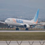 flydubai Boeing 737 touching down on a runway, illustrating Dubai airport cancellations today and flydubai schedule changes