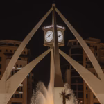 The Deira Clock Tower and its fountain lit up at night in Deira, the Dubai district that is home to the Al Rigga night market
