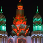 Illuminated domes and towers of a Global Village gate at night, ahead of Global Village ticket prices for Season 31 in Dubai