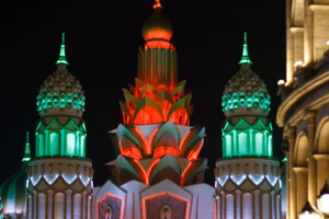 Illuminated domes and towers of a Global Village gate at night, ahead of Global Village ticket prices for Season 31 in Dubai