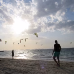 Dozens of kites in the sky over Kite Beach, Jumeirah, with the Burj Al Arab on the horizon, a favourite spot for kitesurfing in Dubai